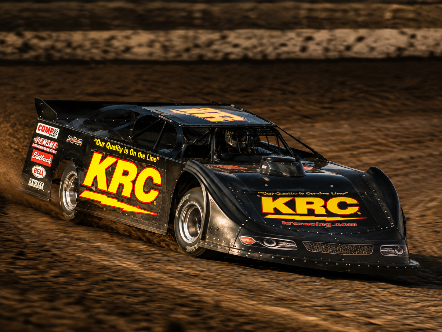 Race car with KRC branding on a dirt track